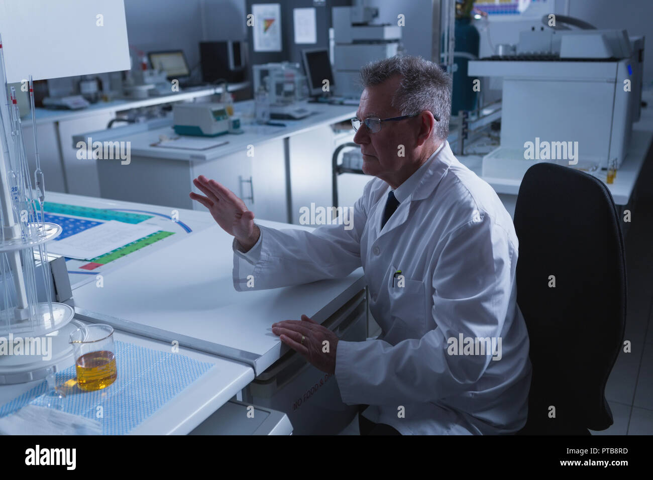 Male scientist using unseen new technology at desk Stock Photo