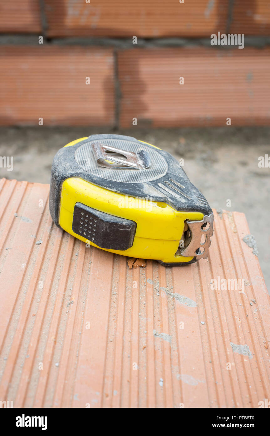 Measuring tape over claybased bricks. Closeup Stock Photo Alamy