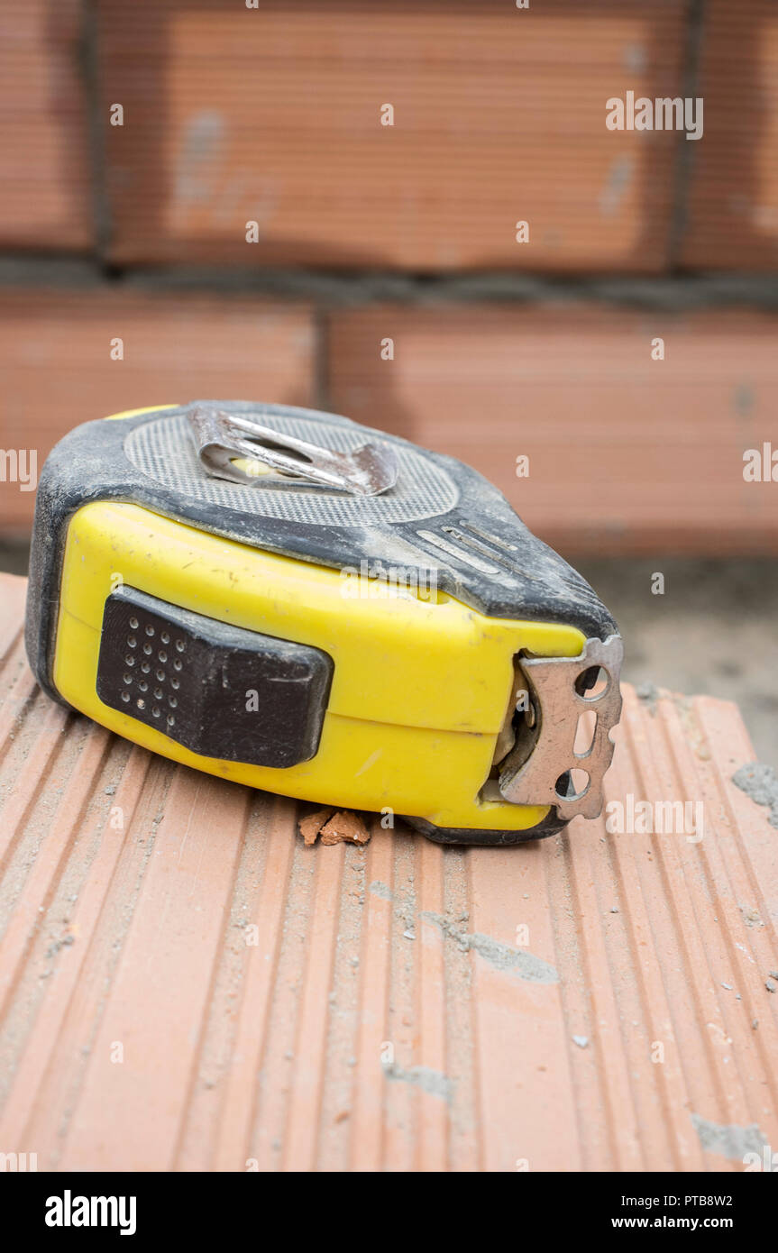 Measuring tape over claybased bricks. Closeup Stock Photo Alamy