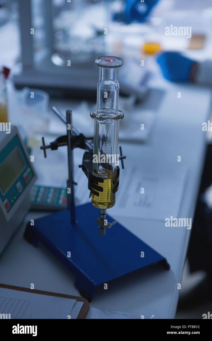 Glass syringe with stand arranged on table in laboratory Stock Photo Alamy