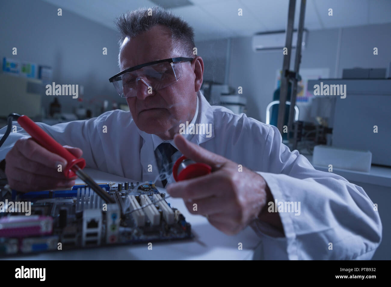 Male scientist soldering circuit board Stock Photo
