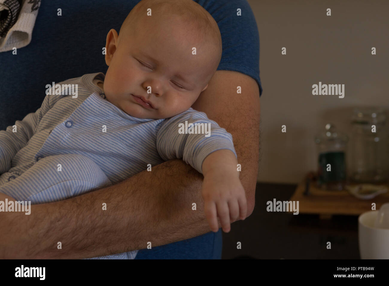 Baby boy sleeping in his father arm Stock Photo Alamy