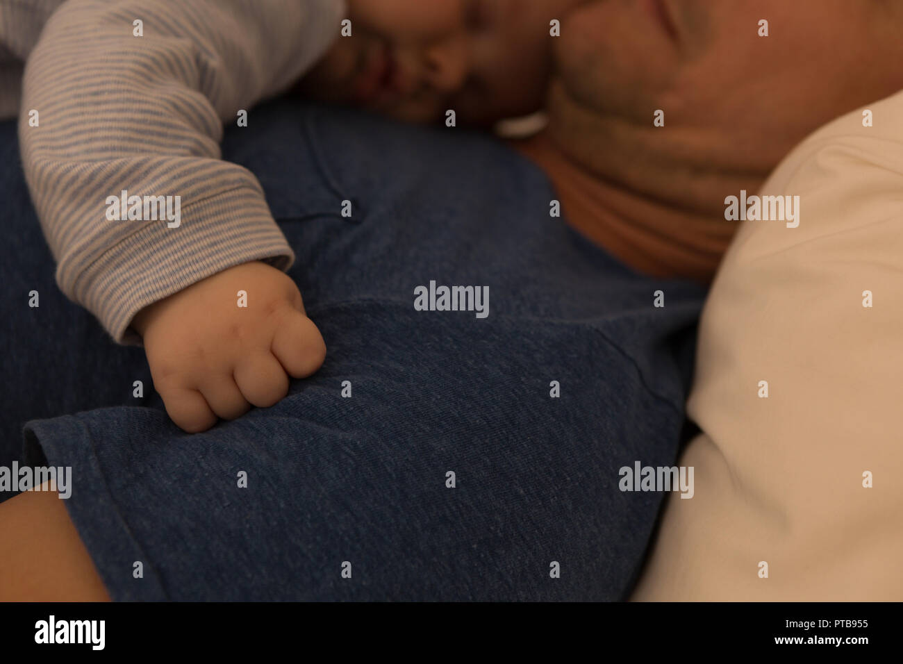 Father and bay boy sleeping in bedroom Stock Photo