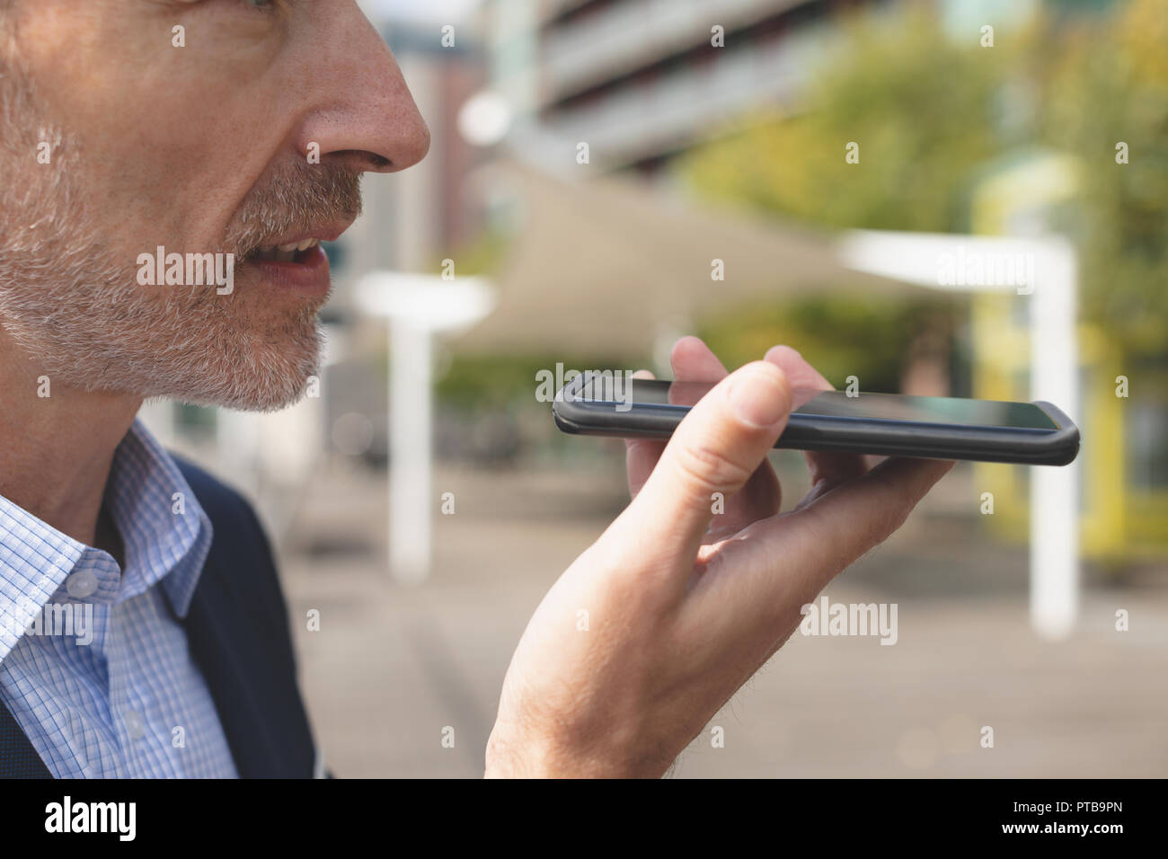 Businessman talking on mobile phone in city Stock Photo