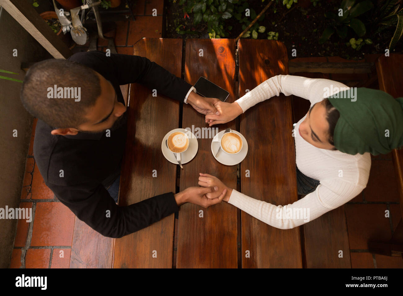 Couple holding hand in cafe Stock Photo