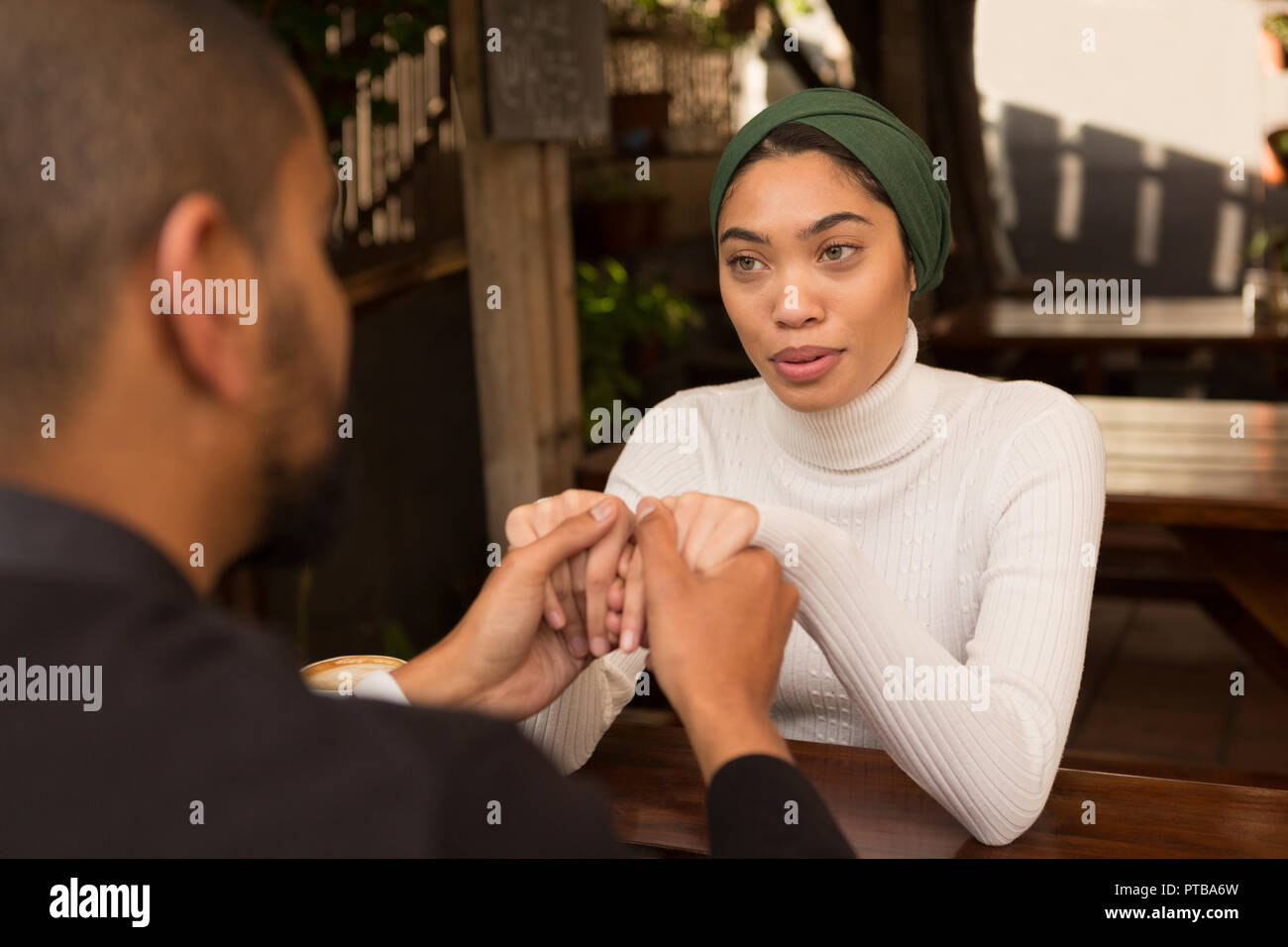 Couple holding hand in cafe Stock Photo