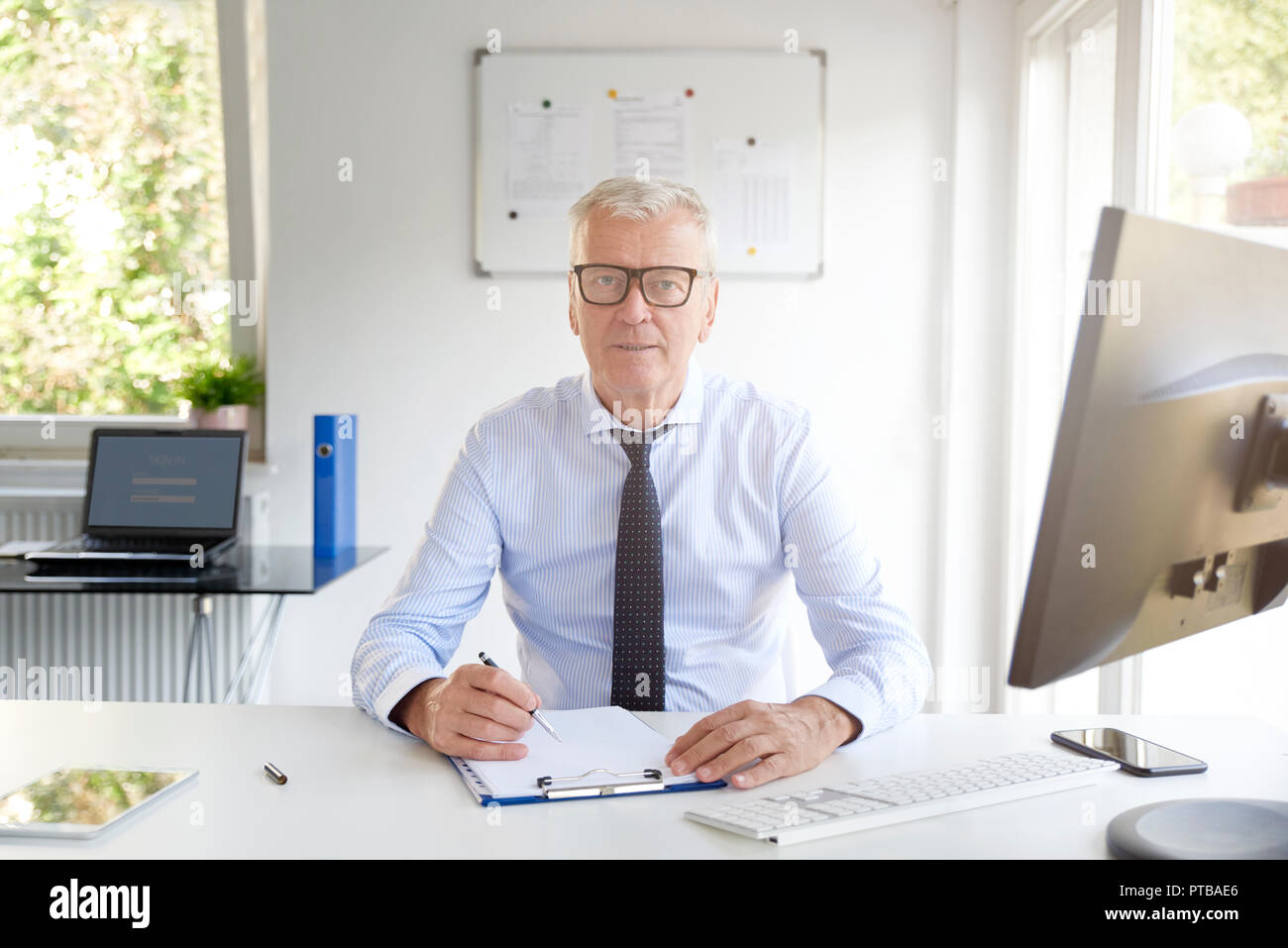 Executive Senior Businessman Doing Some Paperwork While Sitting At