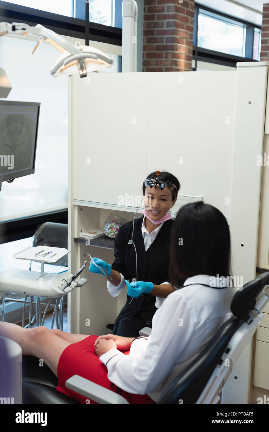 Female dentist interacting with a patient Stock Photo