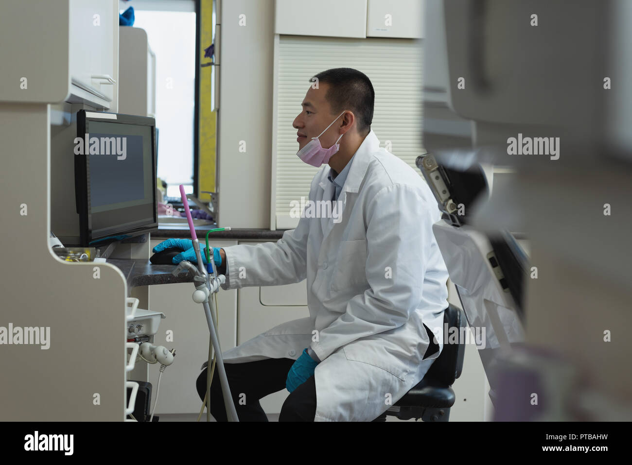 Male dentist using desktop pc in clinic Stock Photo