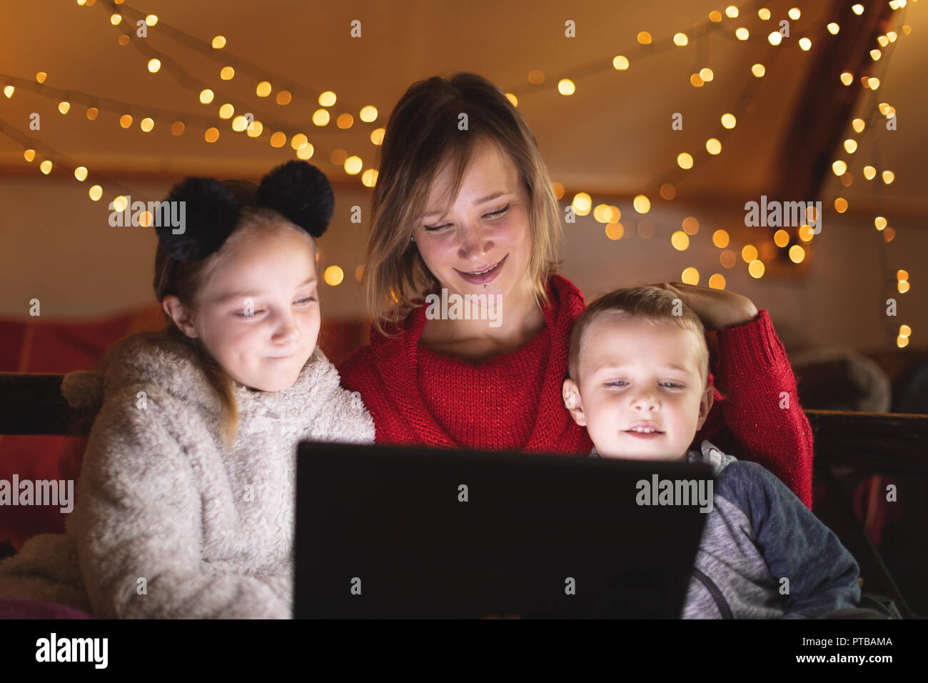 Mother and kids using digital tablet at home Stock Photo