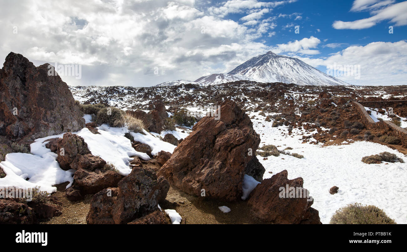 Winter in Teide National Park. Panoramic view of famous Pico del Teide mountain volcano in snow, Tenerife, Canary Islands, Spain Stock Photo