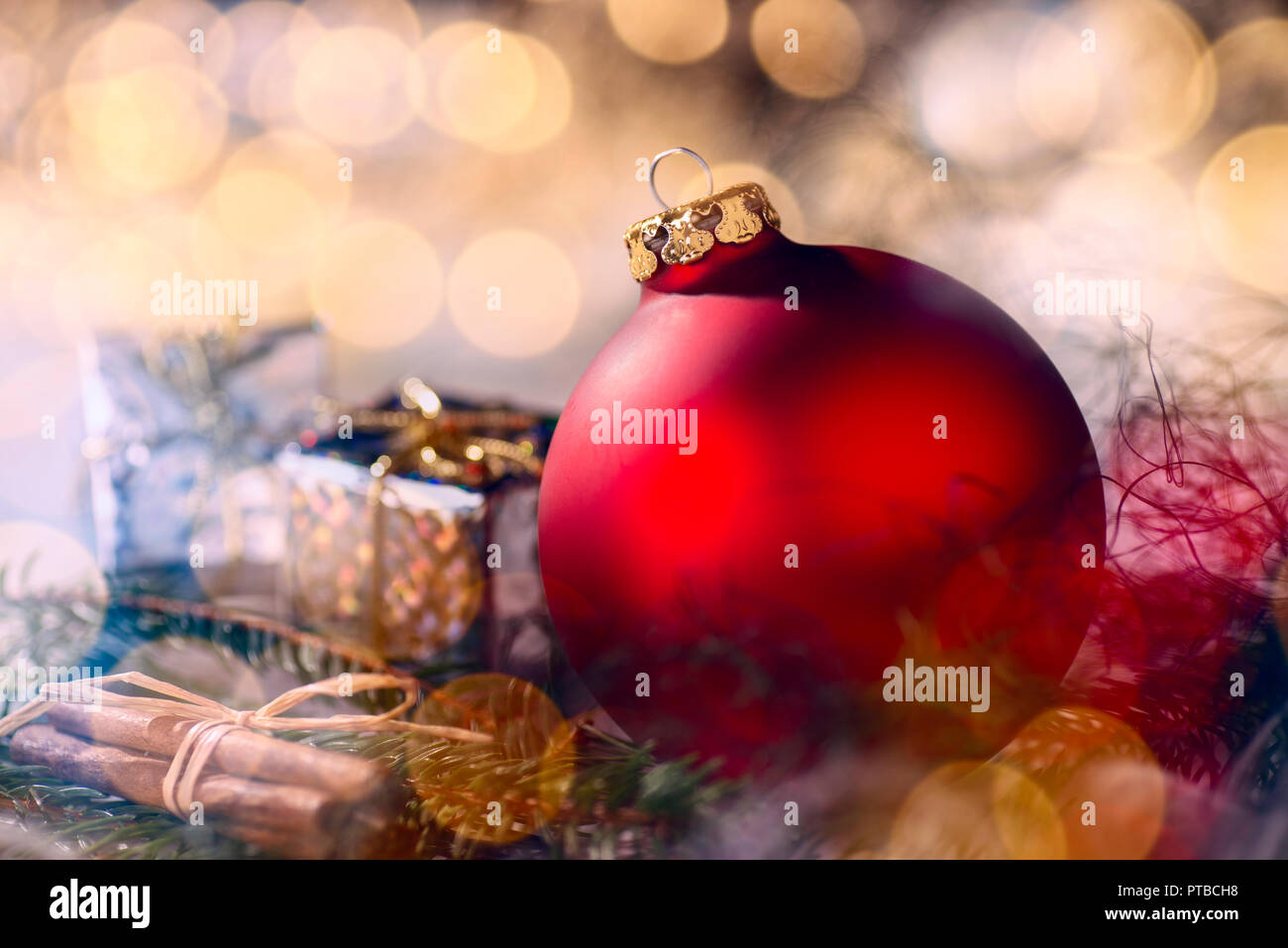 Red bauble and Christmas decoration with fir branches and bokeh Stock Photo