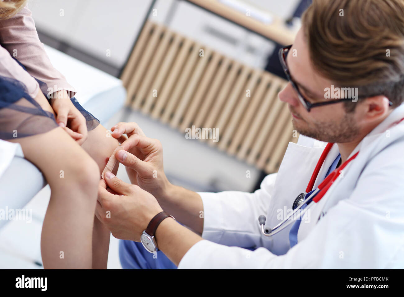 Picture showing little girl in clinic being examined by dermatologist Stock Photo