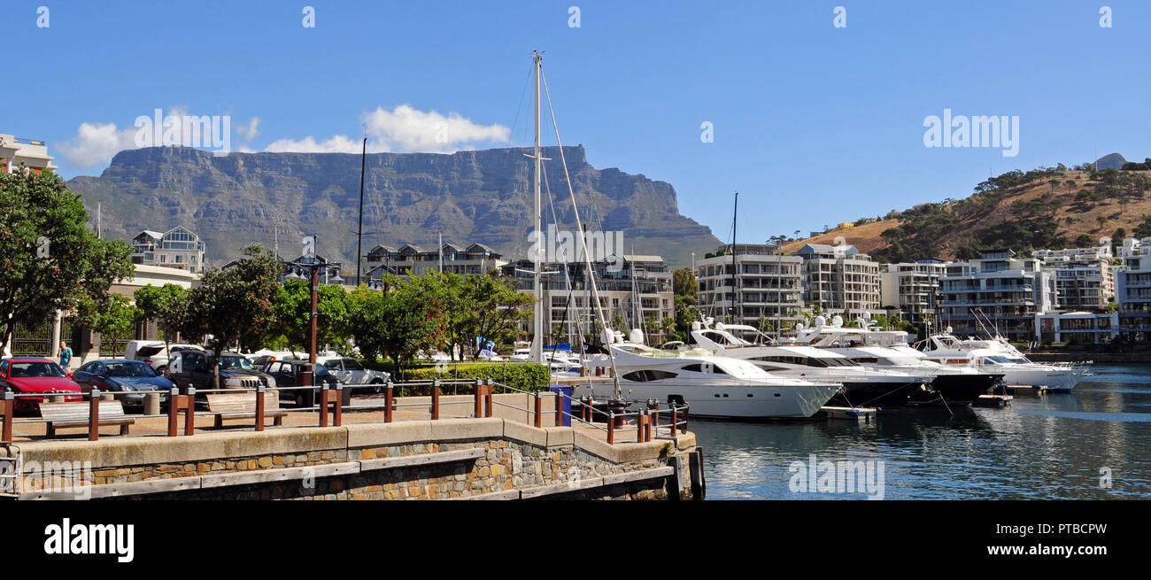 Cape Town, South Africa May 20, 2016: Cape Town and coast line, jetty. Are ships and boats, far mountain on the blue sky background. Summer. South Afr Stock Photo