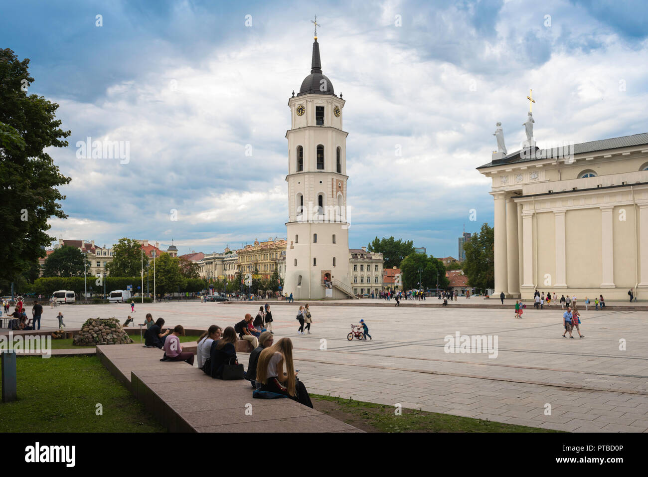 Vilnius Cathedral Square, view of people sitting in Cathedral Square with the Belfry tower and west end of the cathedral in the distance, Lithuania. Stock Photo