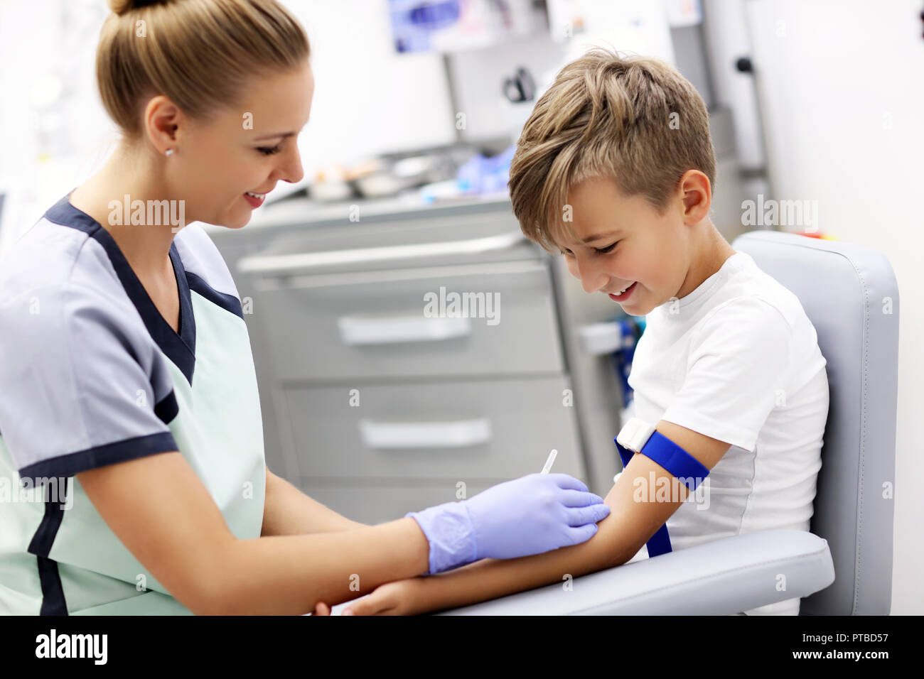 Picture of brave little boy having blood collection for tests Stock