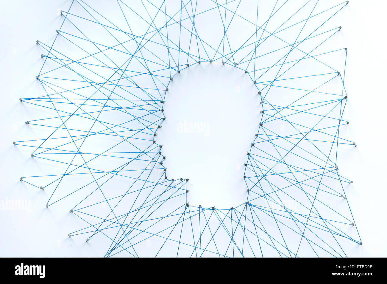 Human head shape made from a large grid of pins connected with string. Communication technology and mental health concept Stock Photo