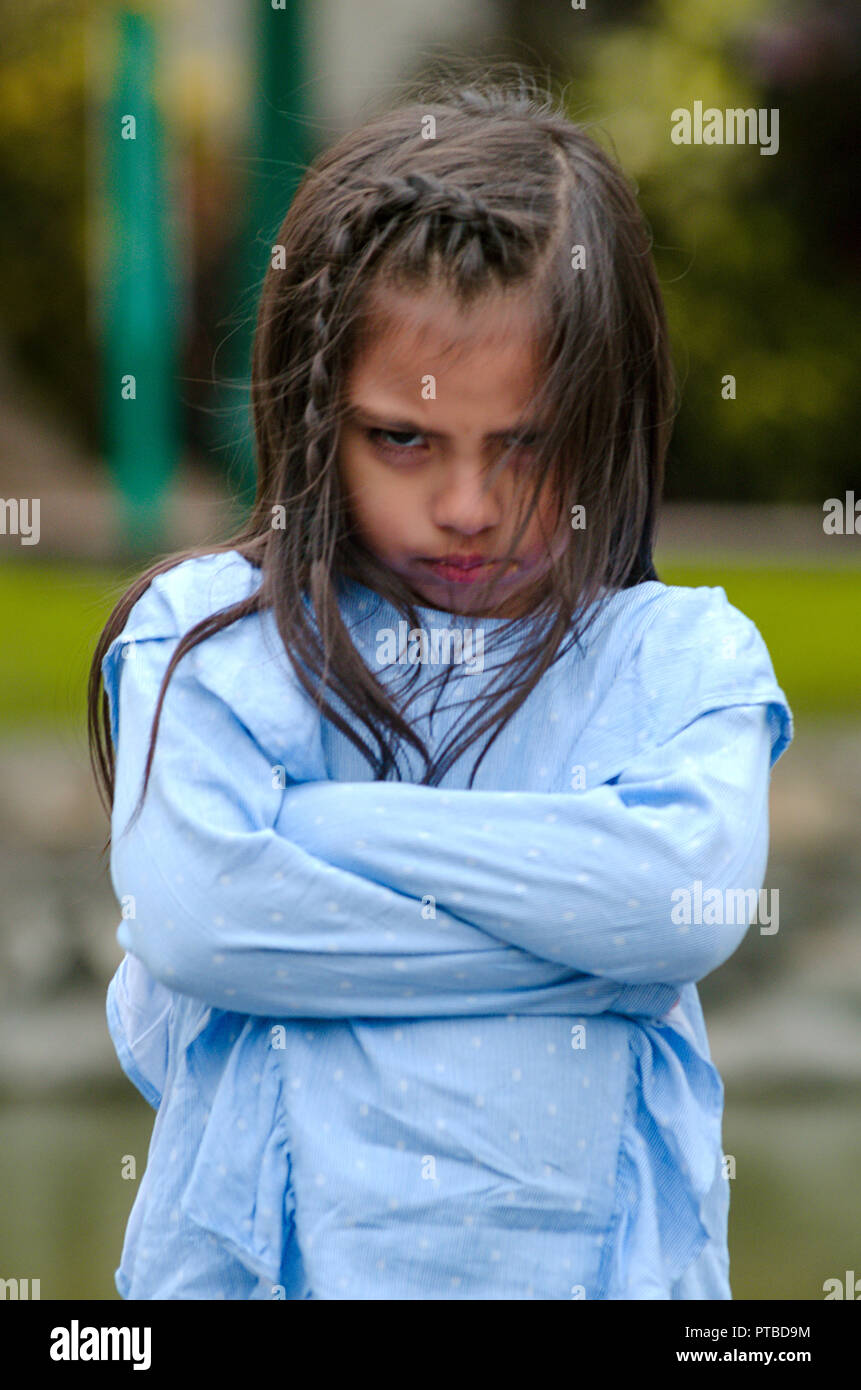 Angry little girl showing frustration and disagreement in the street Stock Photo