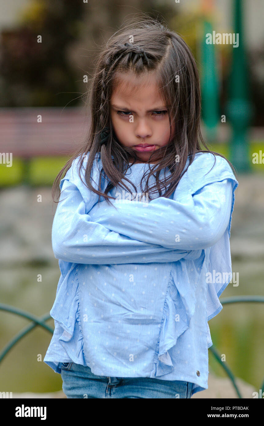 Angry little girl showing frustration and disagreement in the street Stock Photo