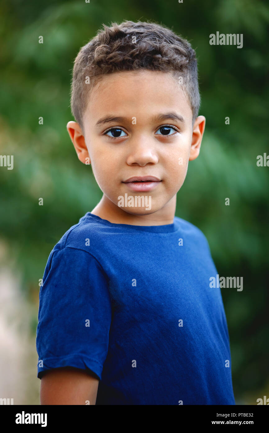 Beautiful latin child with a green natural background Stock Photo