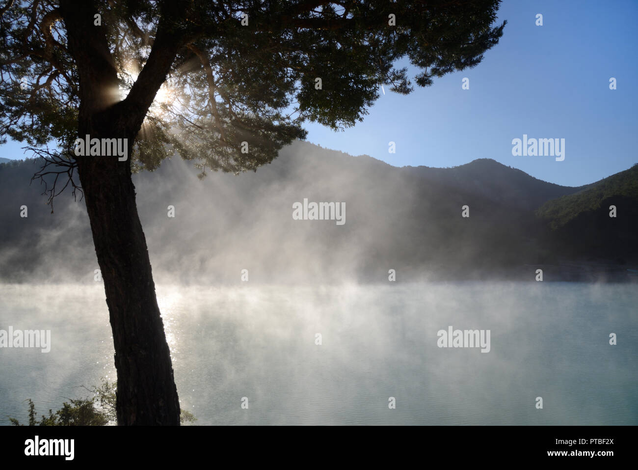 Morning Mist Rises on the Castillon Lake in the Verdon Valley Alpes-de-Haute-Provence France Stock Photo