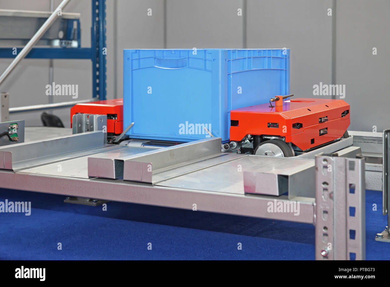 Automated Pallet Shuttle For Crat Transport at Shelves in Warehouse Stock Photo