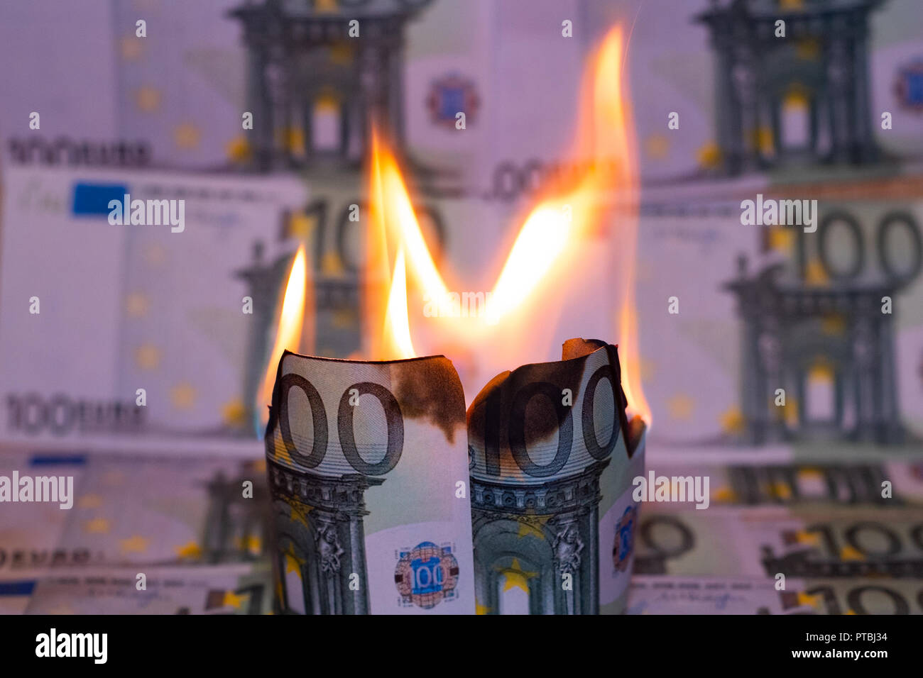 One hundred euro bill in Europe currency is on fire. Stock Photo