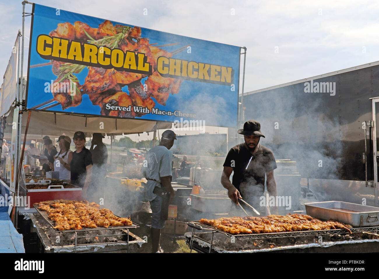 Charcoal grilled chicken being cooked outdoors en masse at the 2018 Cleveland Air Show in Cleveland, Ohio, USA. Stock Photo
