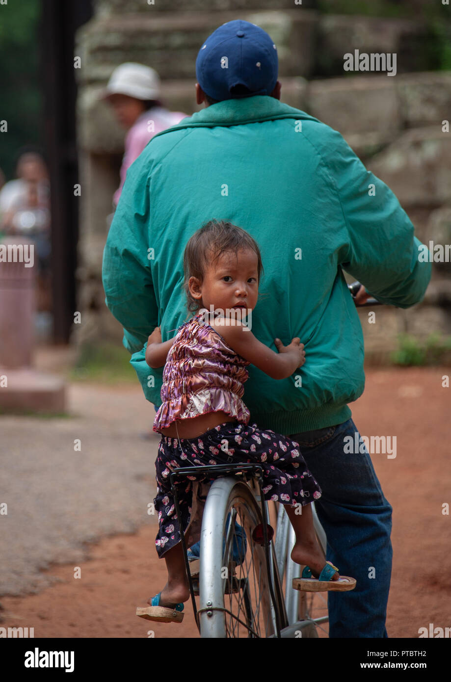 Father taking his son by bike, Siem Reap Province, Angkor, Cambodia Stock Photo