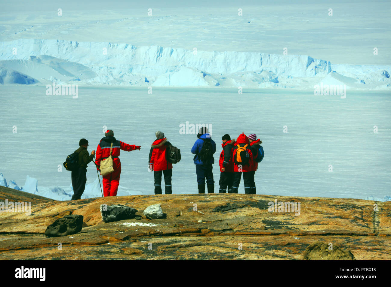 Antarctica  March 23, 2016:People, scientists, researchers are on the mountain of stone. Near the shore of the ocean and icebergs. Antarctic. Stock Photo