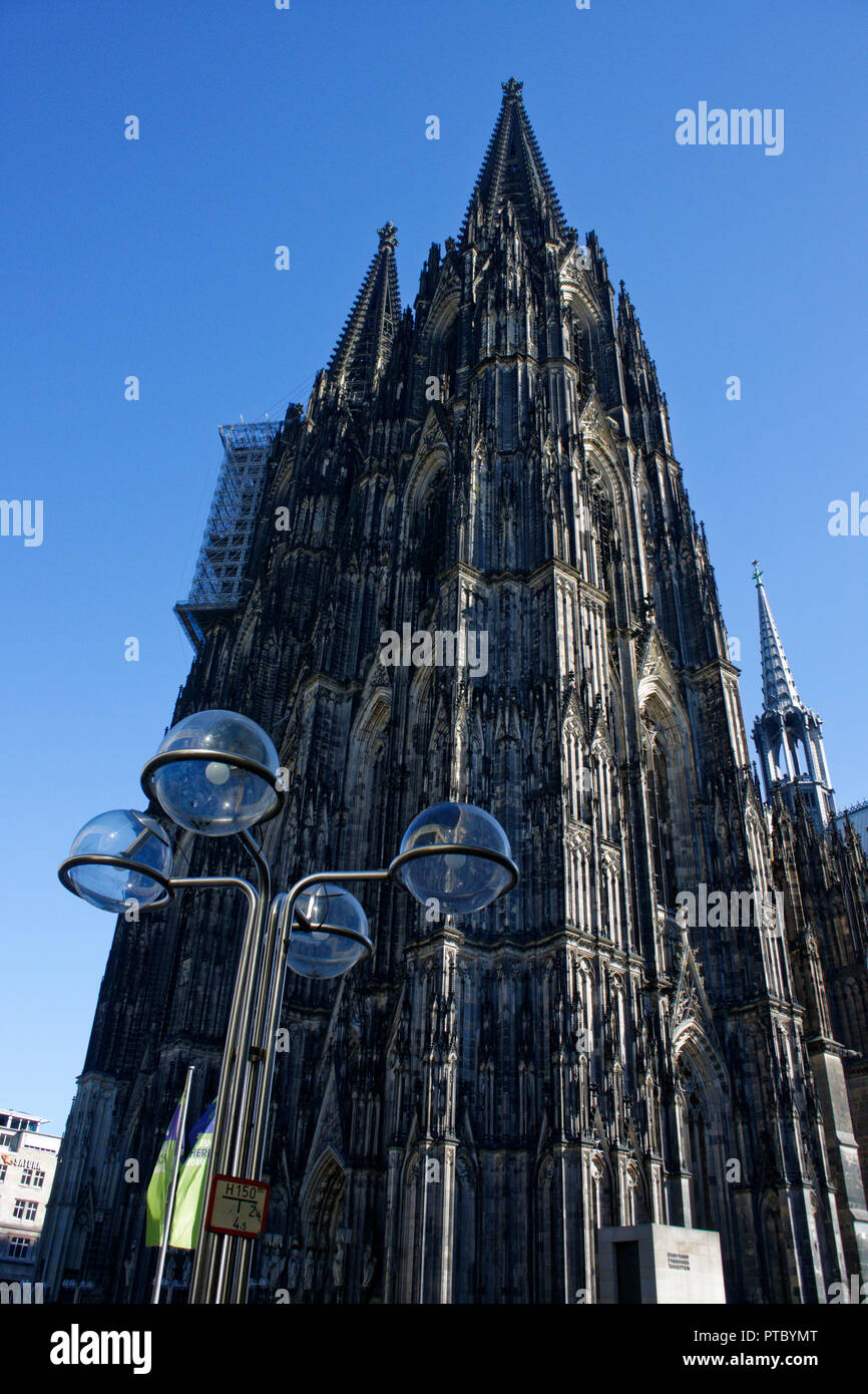 The tall twin spires of Cologne's gothic catherdral dwarf every other building in the city centre Stock Photo