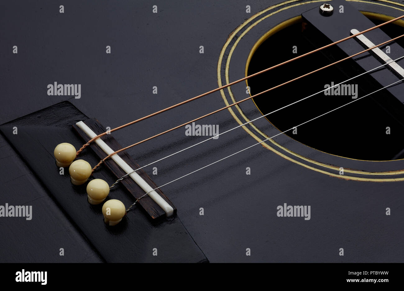 Gibson TG1 detail showing how strings fit with pegs Stock Photo