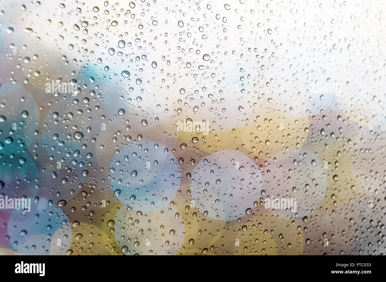 Waterdrops on a glass surface windows with bokeh background Stock Photo