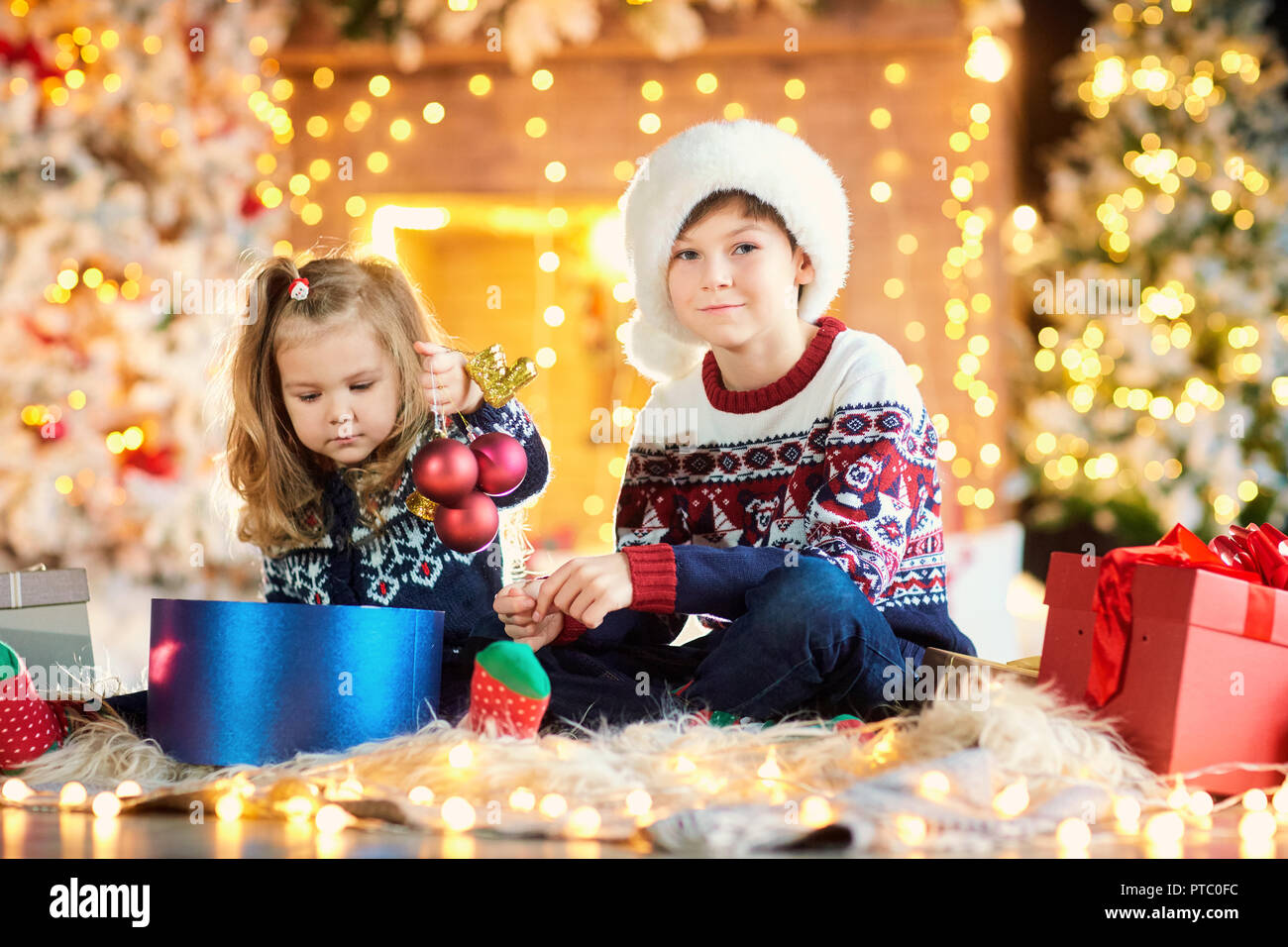 Children in a santa hat playing on Christmas Day. Stock Photo