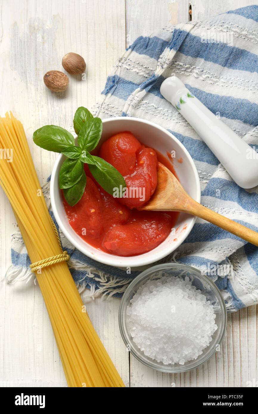 Italian peeled tomatoes in the white bowl - closeup Stock Photo