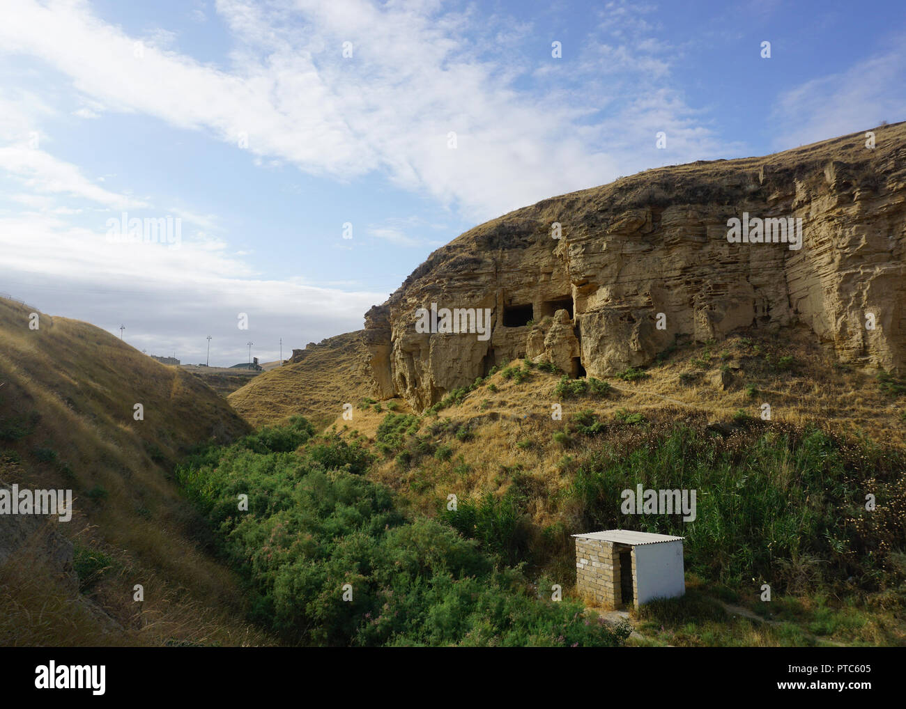 Diri Baba Grotto Caves carved in Massif with Public Toilet Stock Photo