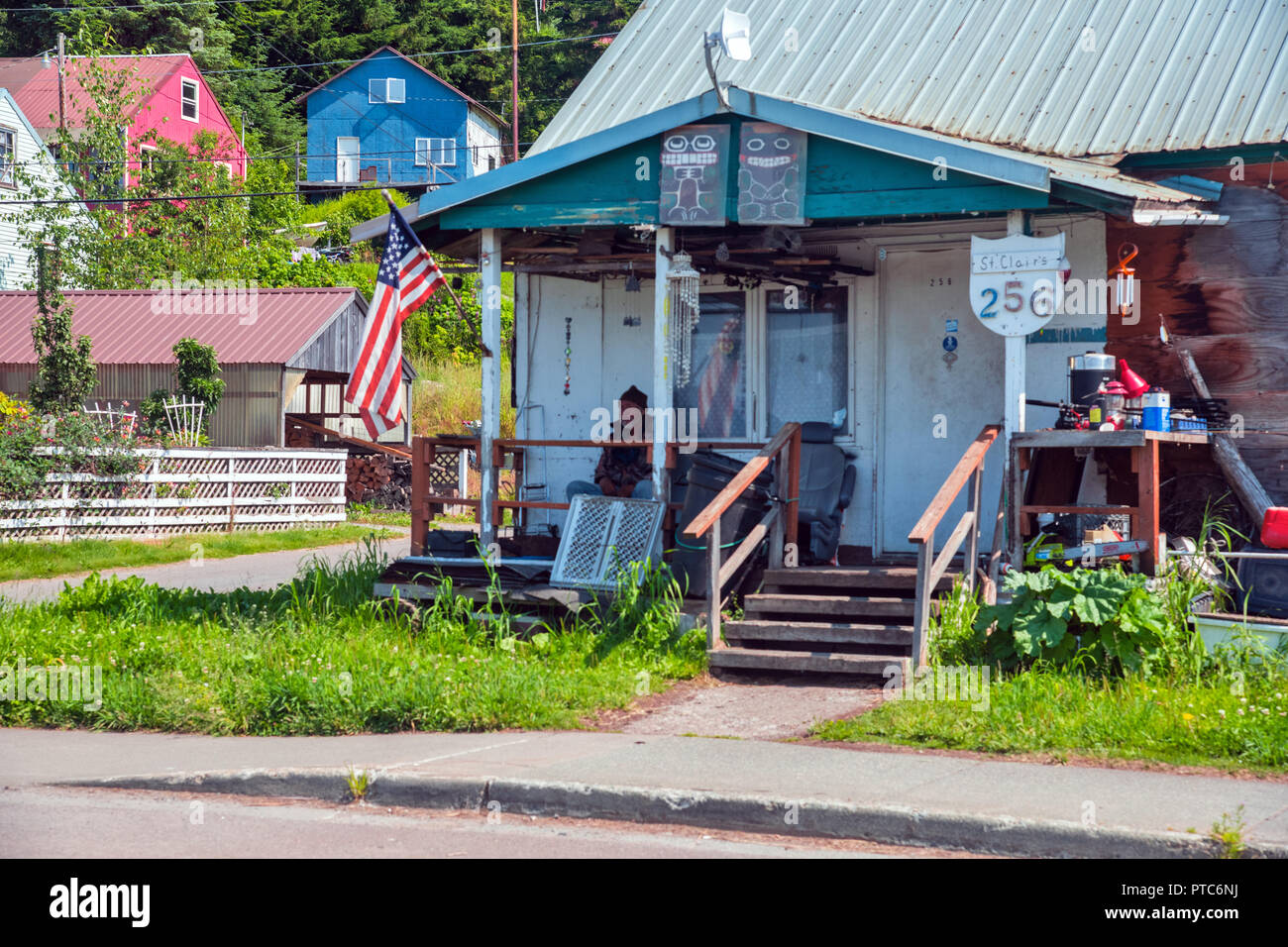 A local resident sits on the veranda of his house, Hoonah, Alaska, USA