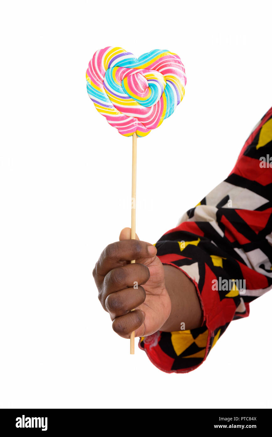Studio shot of hand of fat black African woman holding delicious