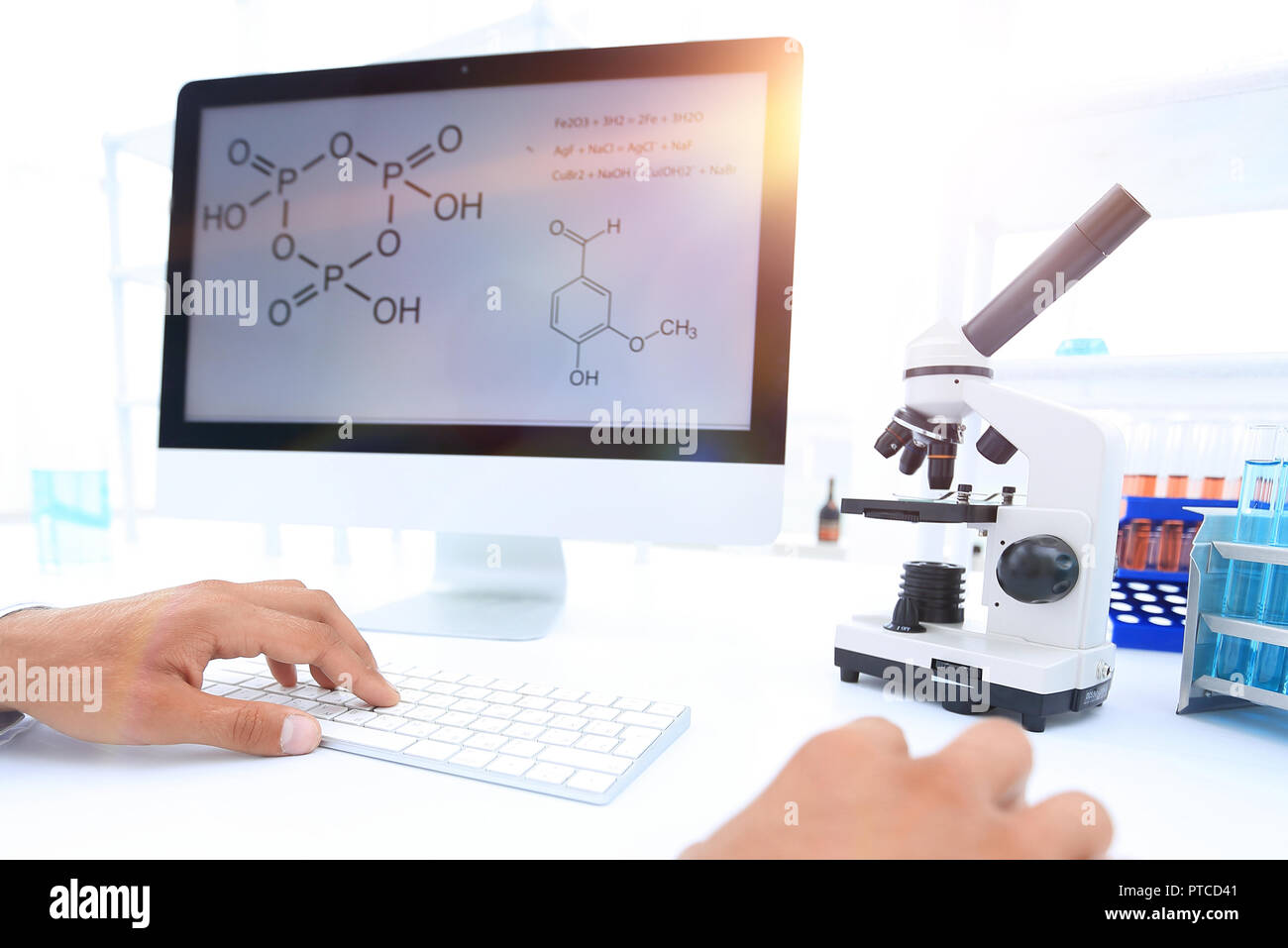 A scientist uses a computer and a microscope Stock Photo - Alamy