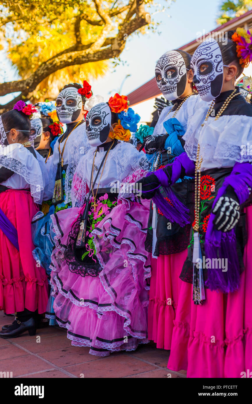 Group of unrecognizable women wearing traditional sugar skull masks and costumes for Dia de los Muertos celebration Stock Photo