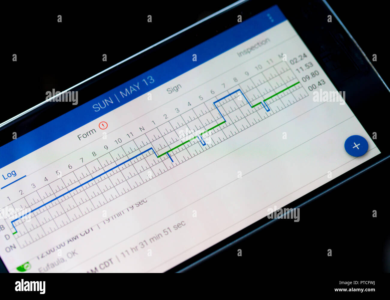 CHICAGO, IL, USA - MAY 14, 2018 - Electronic logging device for trucking industry with hours of service displayed on smartphone screen Stock Photo