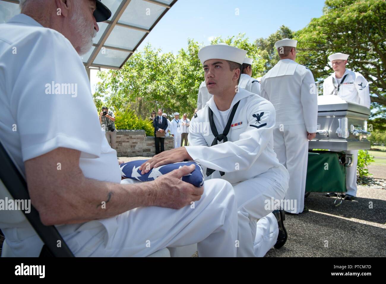 James Temple receives an American Flag during a funeral ceremony
