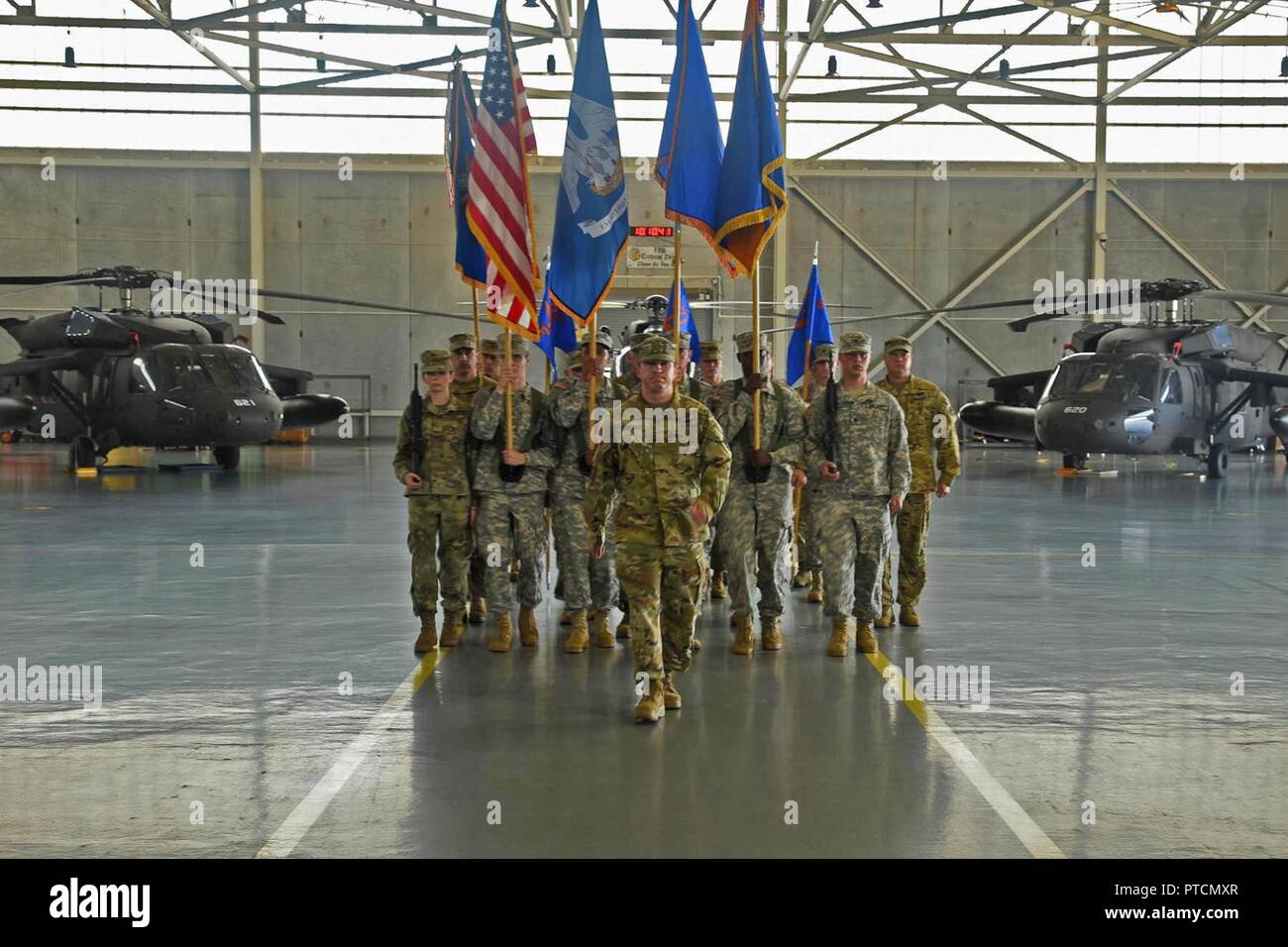 Louisiana National Guardsman Maj. Jacques Comeaux leads the State Aviation Command colors forward during an official change of command and promotion ceremony at Army Aviation Facility #1 in Hammond, Louisiana, July 9, 2017. During the ceremony, Brig. Gen. Patrick Bossetta was pinned with the one-star rank after relinquishing command of the State Aviation Command to Col. John Plunkett and command of the 204th Theater Airfield Operations Group to Lt. Col. John Bonnette. Stock Photo