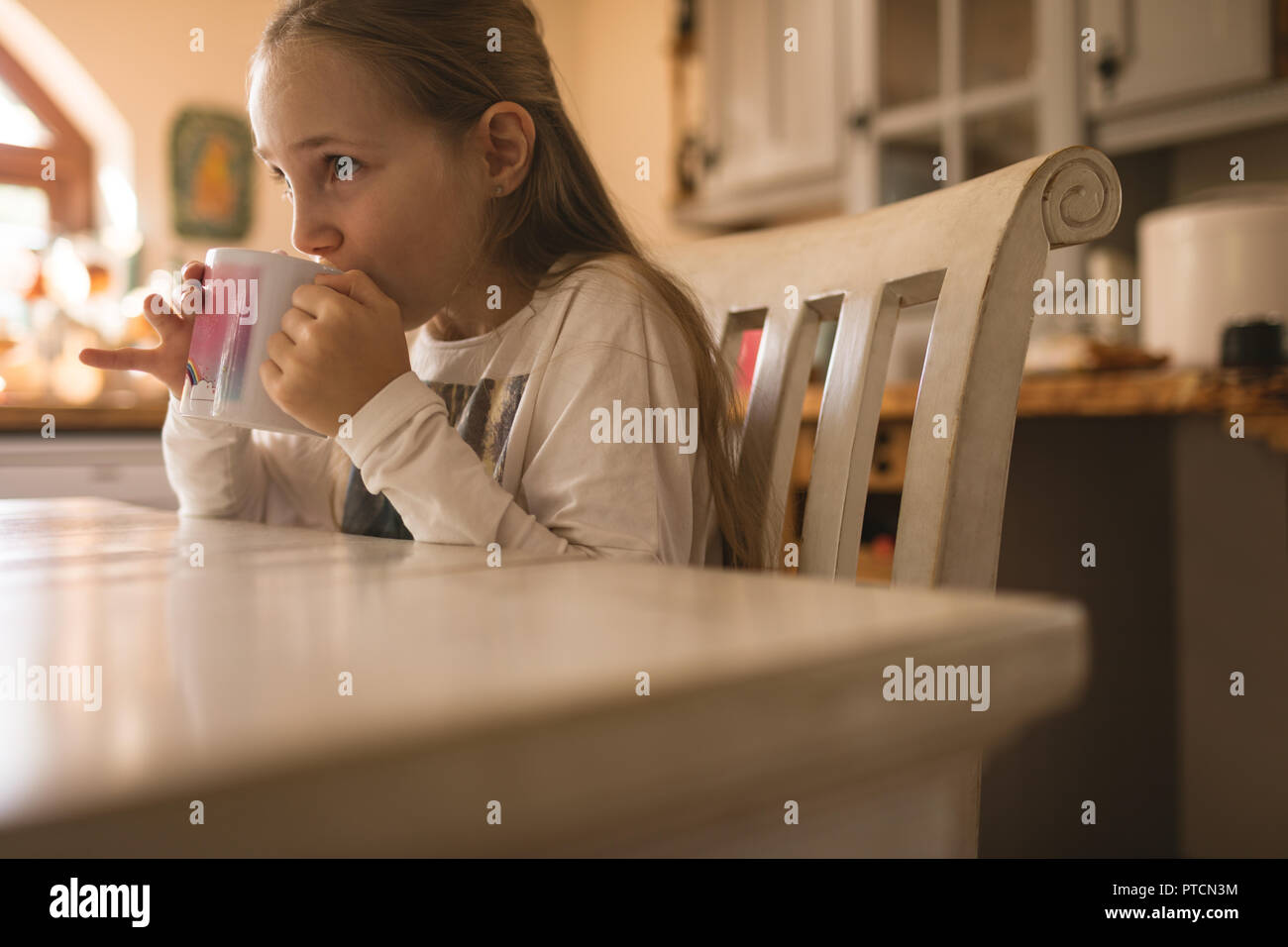 Girl drinking coffee at home Stock Photo