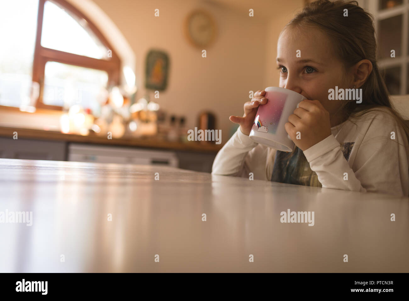 Side view of girl drinking coffee at home Stock Photo