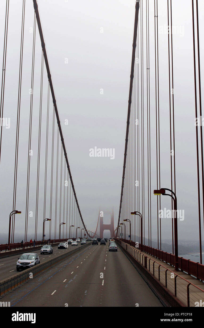 Driving across the Golden Gate Bridge on a very foggy day with the ...