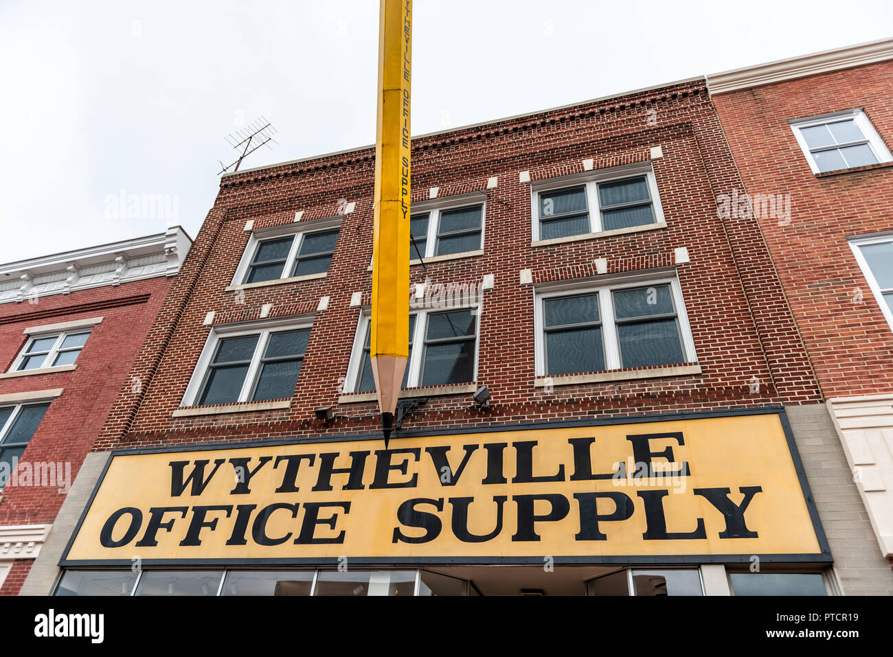 Wytheville, USA - April 19, 2018: Small town village sign for office supply in southern south Virginia with largest big pencil exterior Stock Photo