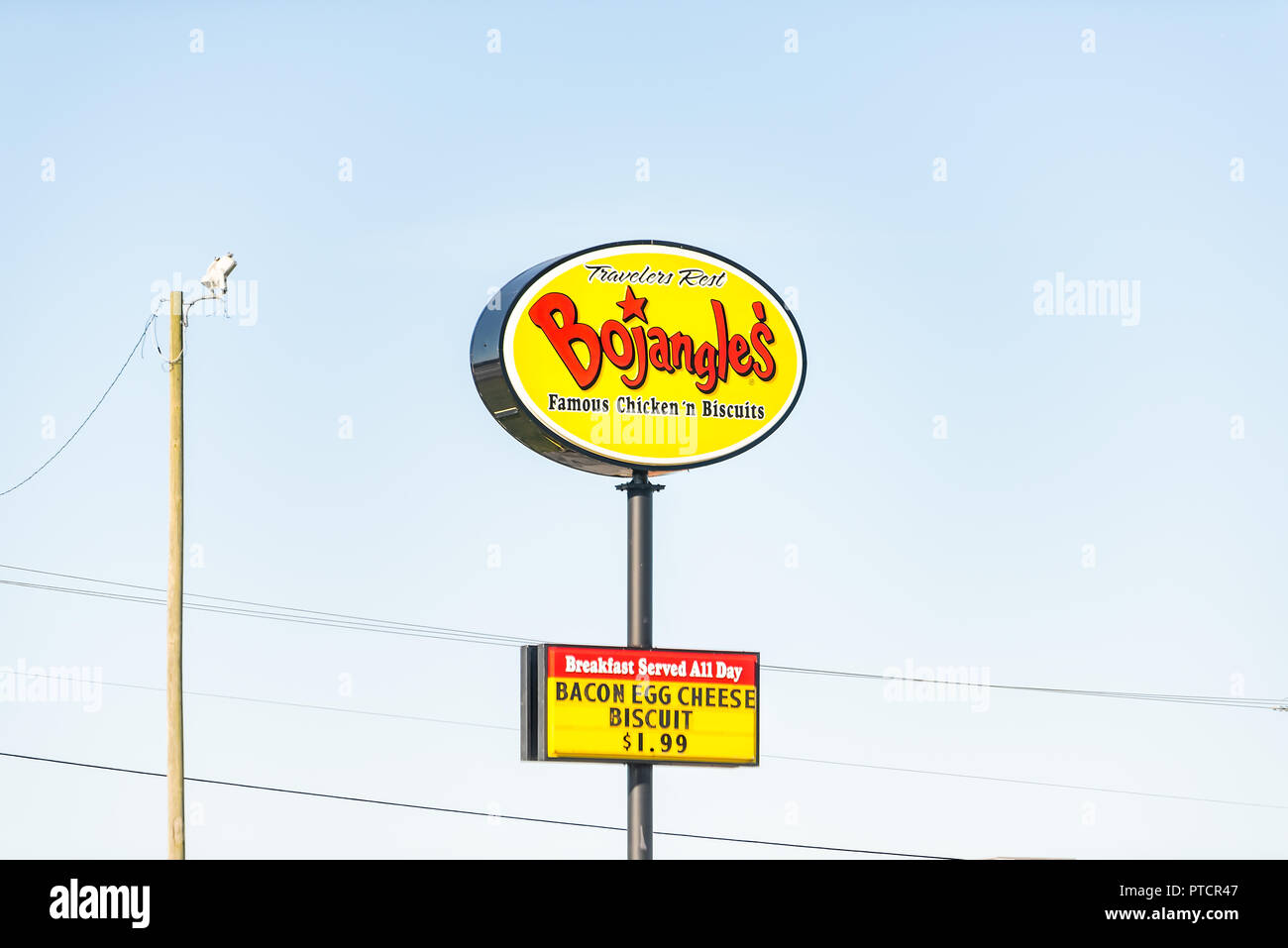 Greenville, USA - April 20, 2018: Bojangles large colorful sign on highway road isolated against blue sky fast food fried chicken and biscuits breakfa Stock Photo