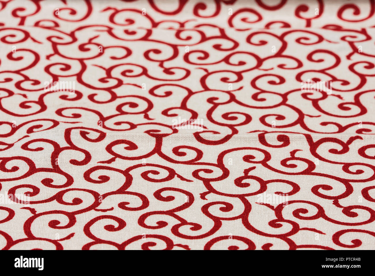 Highly detailed all over background texture of traditional japanese red and white leaves shaped pattern design textile in synthetic fabric. Stock Photo