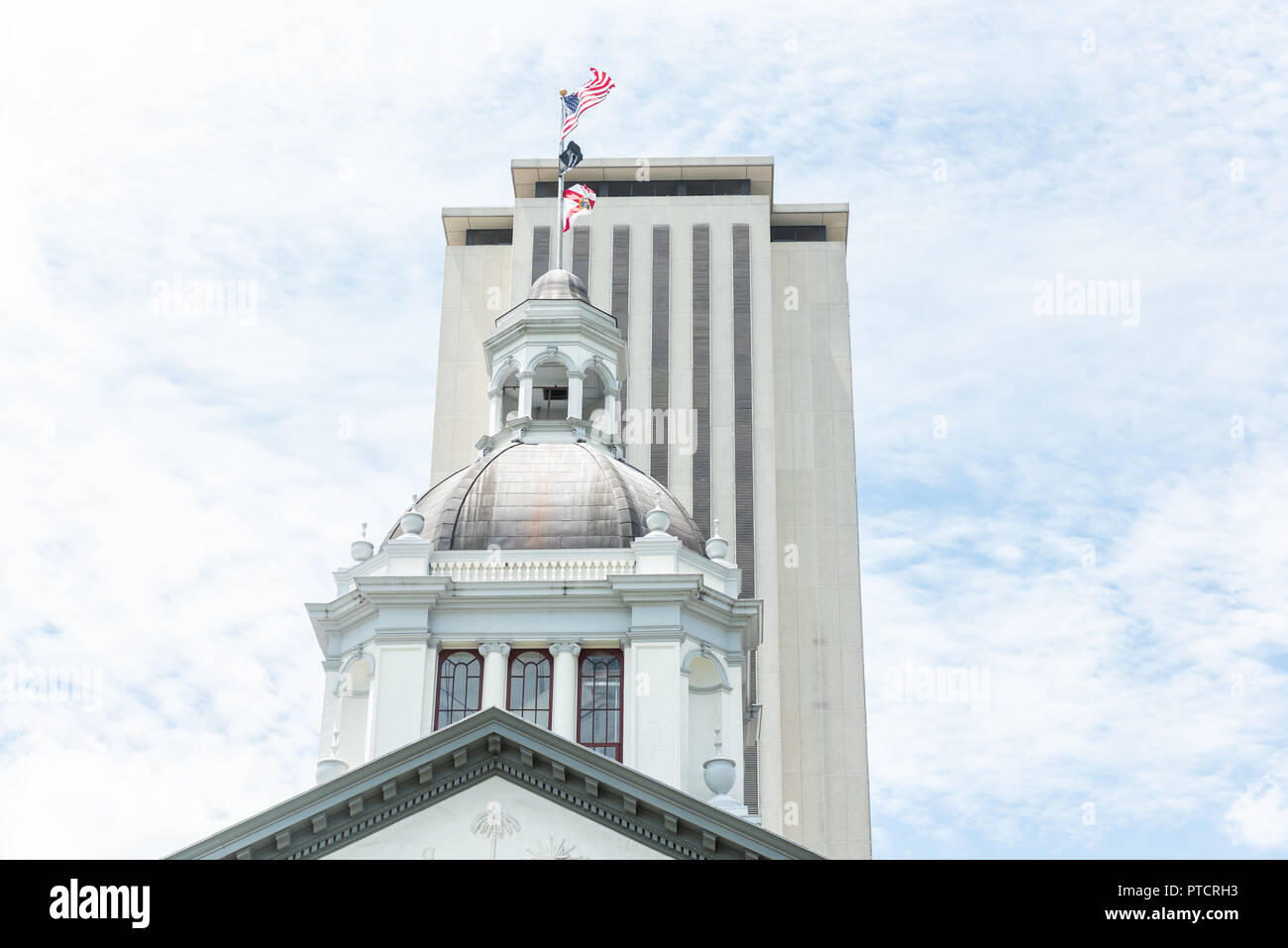 Tallahassee, USA - April 26, 2018: Exterior state capitol building in Florida during sunny day with modern architecture of government, flags Stock Photo